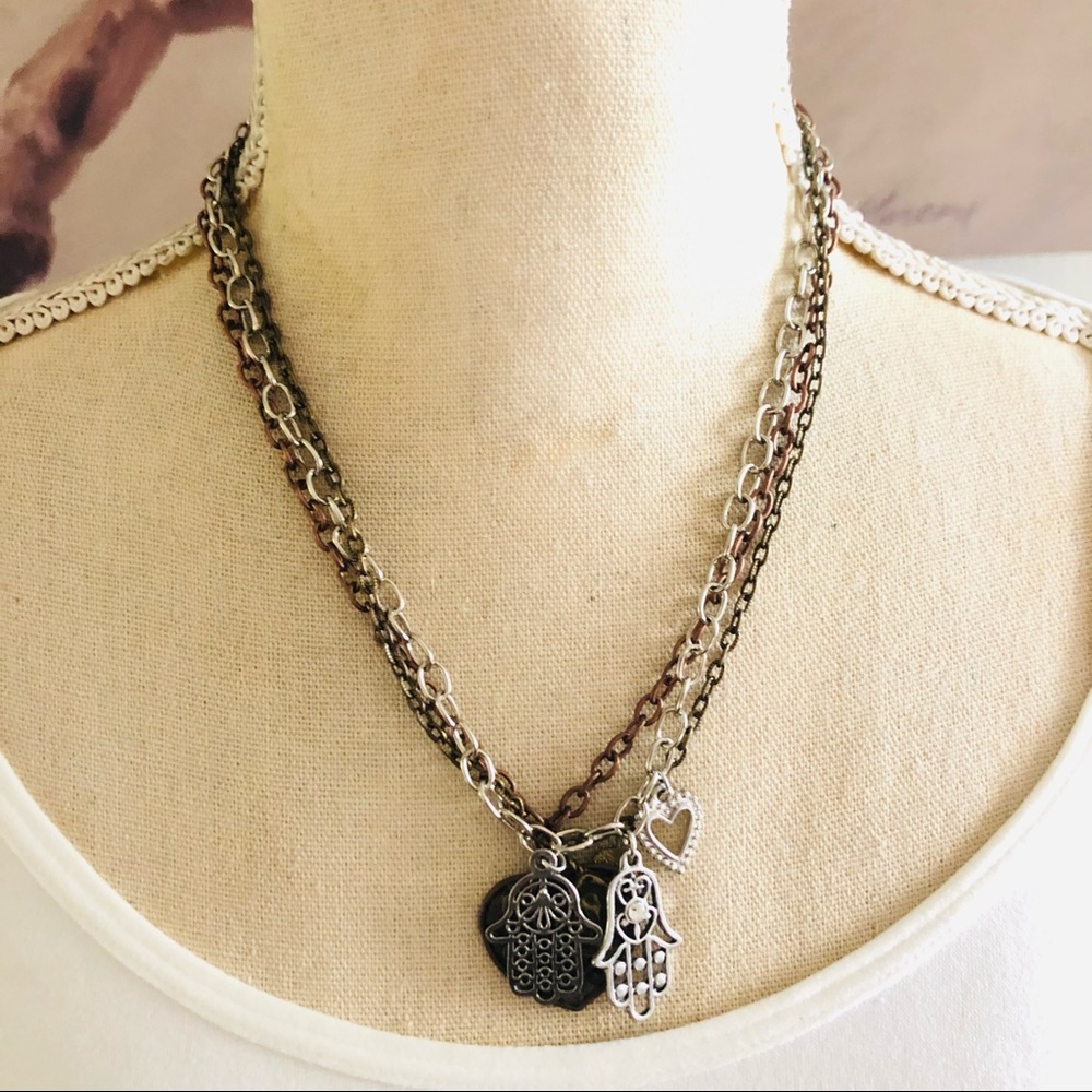 Tri-tone metal triple strand chain hamsa and heart charms necklace